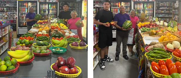 Store employees stand with fresh fruits and vegetables that are available for purchase