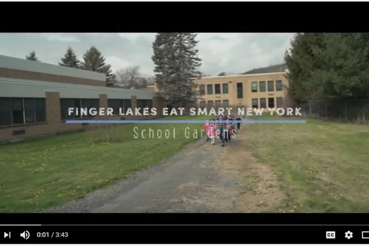 screen shot of beginning video with a farmer and school children