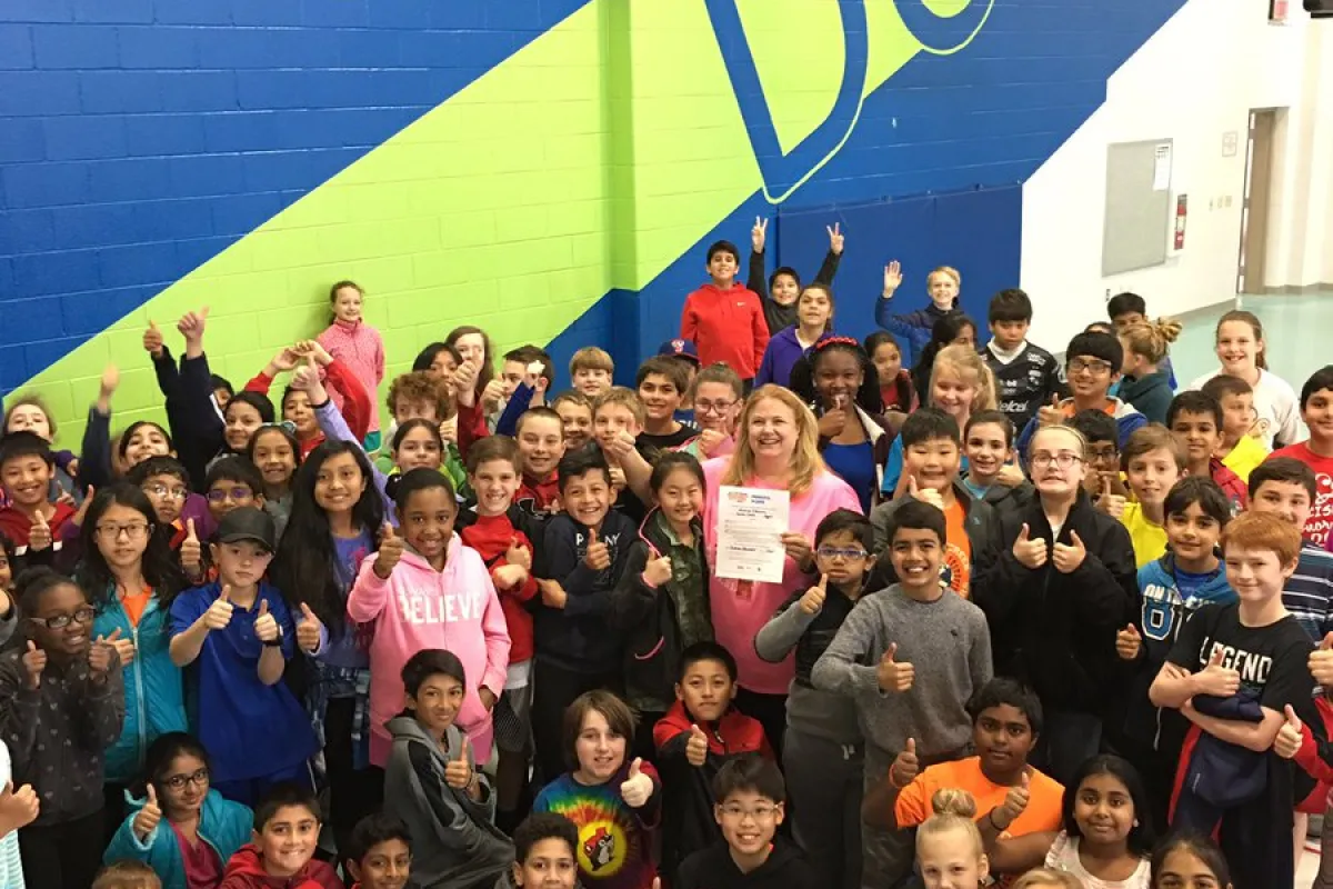 group of kids in a gym posing for a picture
