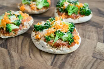 english muffin pizzas topped with broccoli & carrots