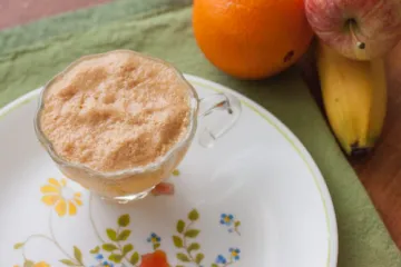 overhead view of orange delight juice in a glass
