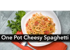 One Pot Cheesy Spaghetti with a bowl of spaghetti and some green garnish next to the bowl